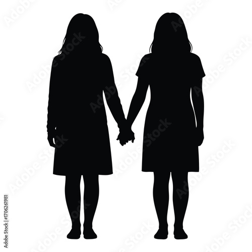 Silhouettes of two young girls holding hands standing together unity friendship concept silhouette