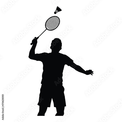 Silhouette of a badminton player serving the shuttlecock in dynamic action silhouette
