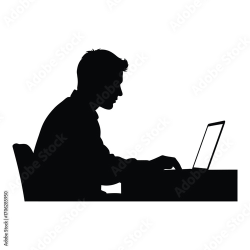 Silhouette of a man working diligently on a laptop computer at a desk silhouette