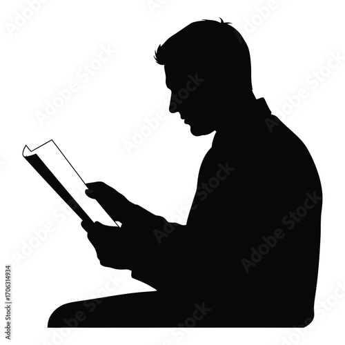 Silhouette of man deeply focused while reading a book or document silhouette