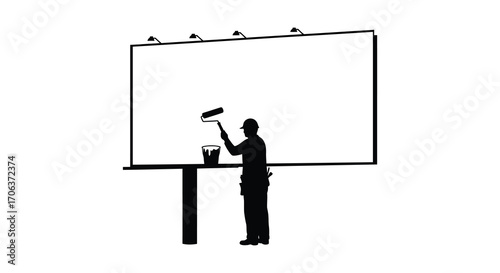 artist painting large billboard under spotlights silhouette