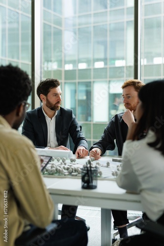 Group of multiethnic architects thinking about residential project