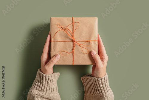 Autumn and winter vibes, Thanksgiving day, winter holidays present, seasonal sale concept. Woman holding handcrafted gift box. Fall composition