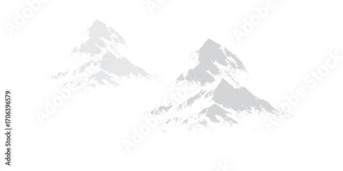 A snowy winter landscape with high alpine mountains under a cold sky