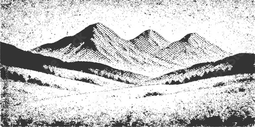 Black and white landscape of snowy mountain peaks under a cloudy sky