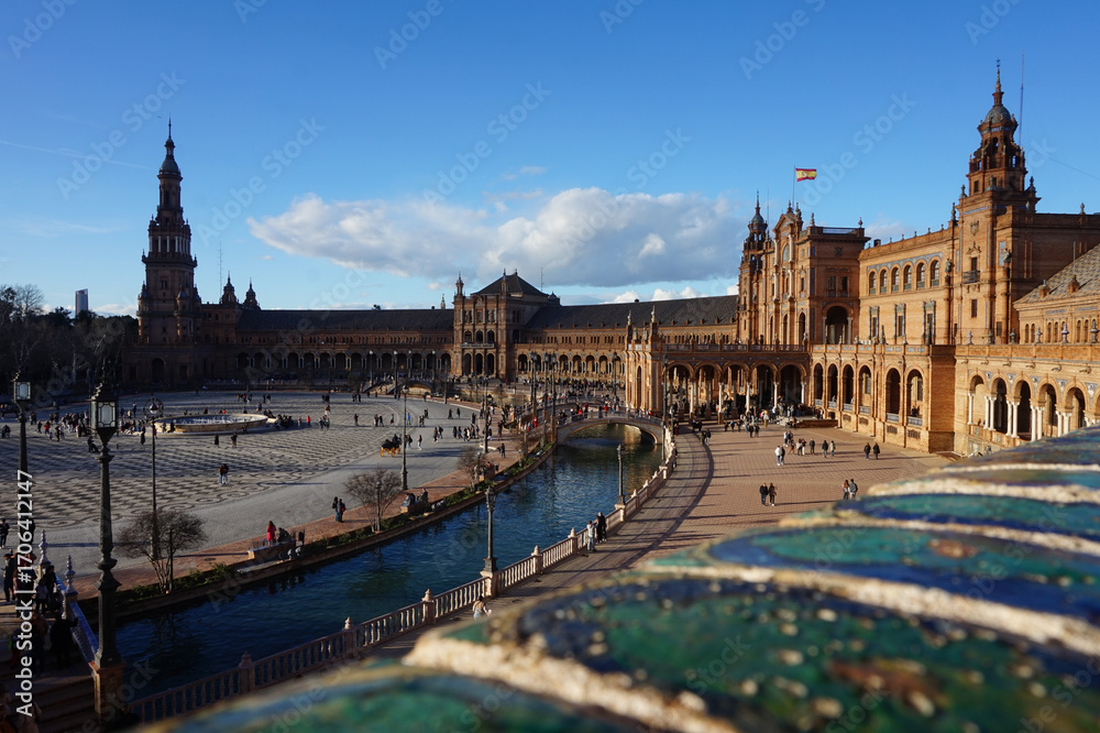 Fototapeta premium Iconic Plaza de España in Seville, Spain - Stunning Renaissance Revival architecture with canal, bridges and tourists on a sunny day