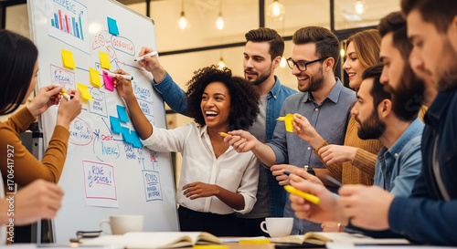 Excited diverse business team collaborating on a creative project, brainstorming strategy with sticky notes on a whiteboard in a modern office