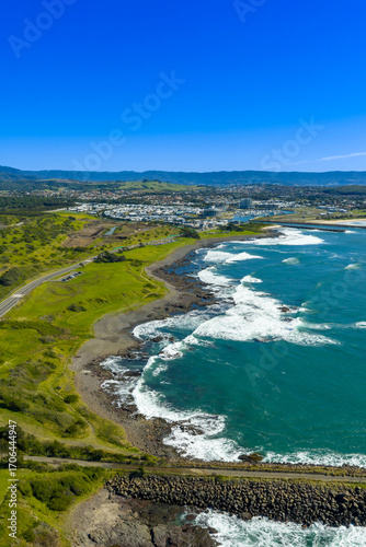 Drone aerial photograph of the rocky coastline of the South Pacific Ocean leading into the town of Shellharbour and Marina in the Illawarra region on the south coast of NSW, Australia.