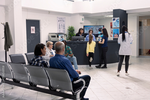 Fotografie Multiethnic group of patients seated in hospital emergency room, awaiting for medical appointments