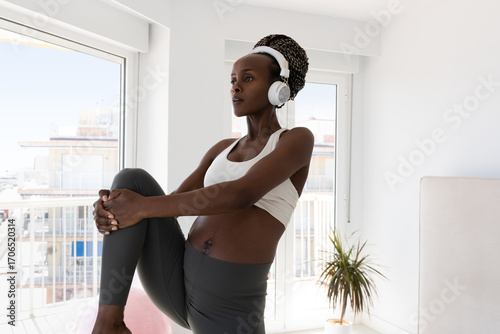 Home Workout Session With Headphones in a Modern Bright Room