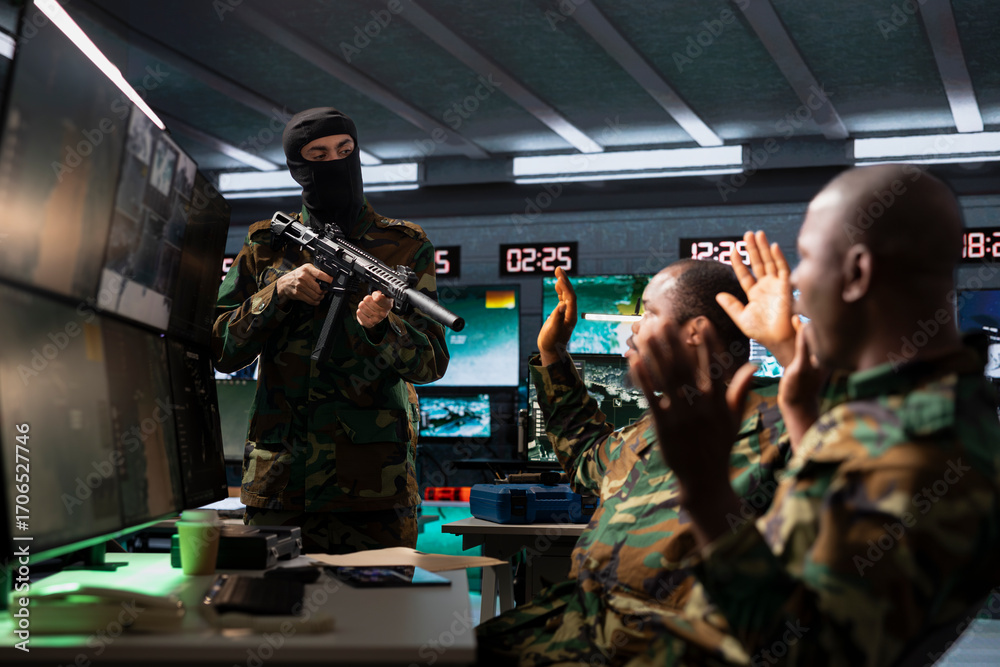 Obraz premium Masked terrorist holding assault rifle invading enemy base of operations, threatening soldiers with opening fire if demands are not met. Rebel forces insurgent using gun to hijack enemy headquarters