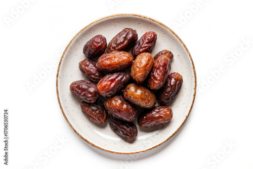 Dates fruits on a plate on a white background, top view, copy space. Organic dried dates.