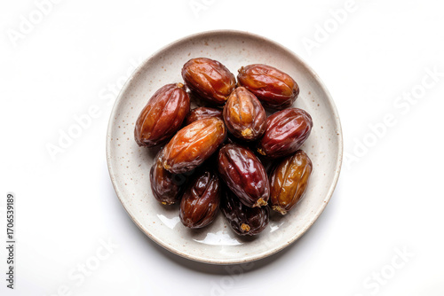 Dates fruits on a plate on a white background, top view, copy space. Organic dried dates.