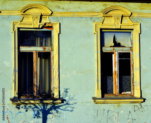 Two old 19 century windows with broken glass.