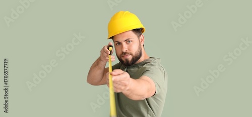 Male worker with tape measu...