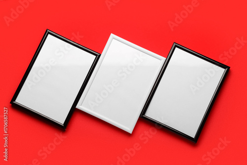 Blank picture frames on red...