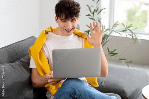 Young man video chatting wi...