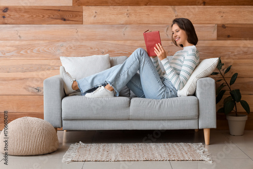 Pretty young woman reading ...