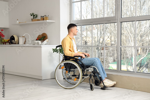 Young man in wheelchair sit...