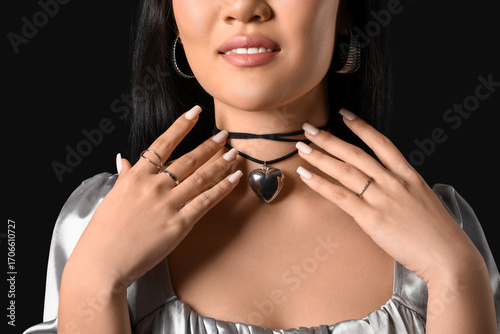 Asian woman in silver jewel...