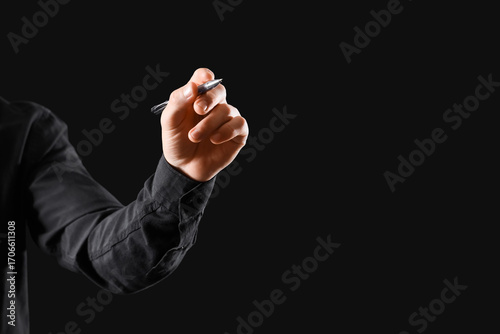 Businessman writing on blac...
