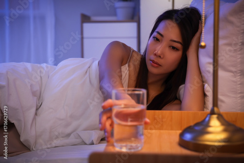 Young Asian woman taking gl...