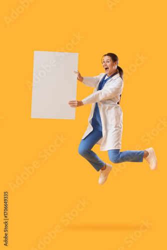 Excited female doctor jumping with blank white signboard, medical professiona...