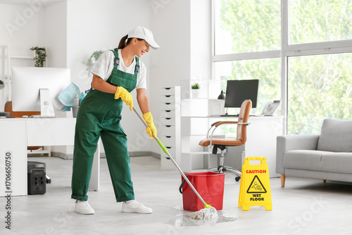 Female janitor mopping floo...