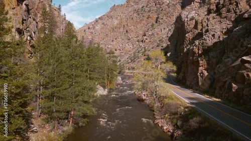 Drive beside a river in Rocky Mountain canyons