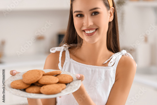 Smiling young woman holding...