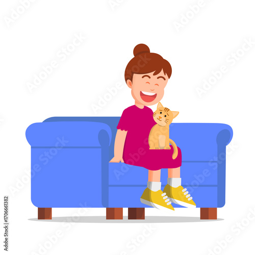 A little girl smiling on a sofa with a cat on her lap