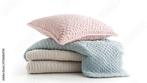 Stack of textured pillows and blankets isolated on white background