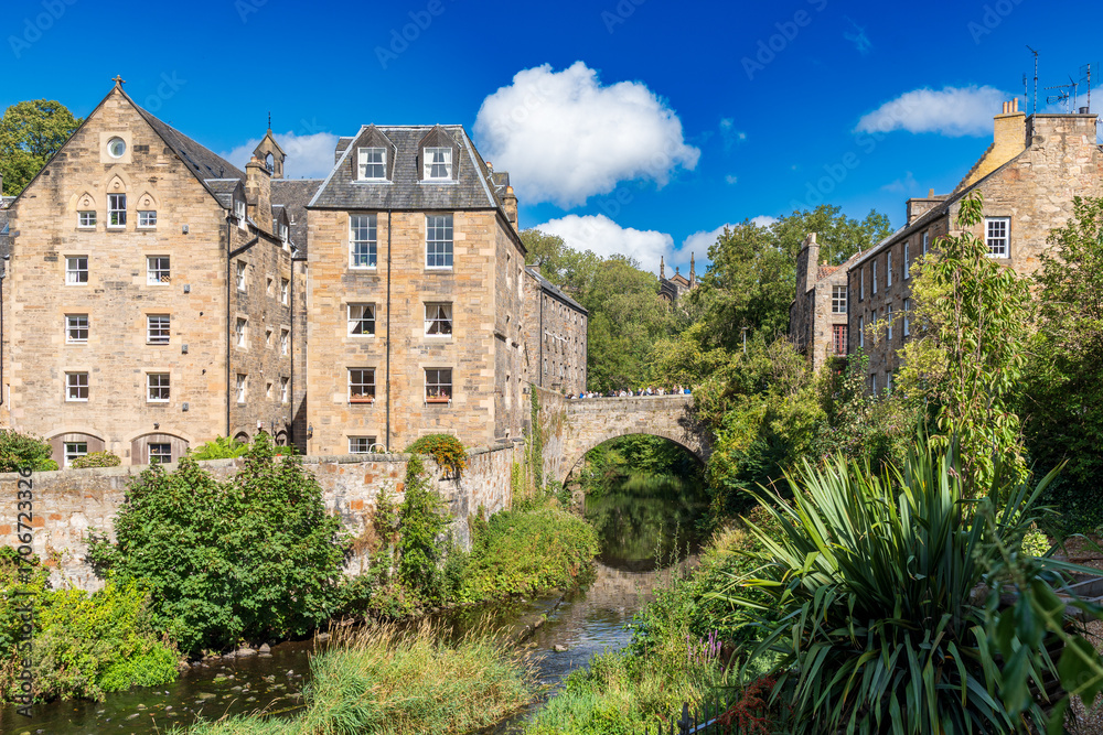Fototapeta premium Peaceful view of Dean Village, Scotland. A historic Edinburgh neighborhood, beautiful oasis by the Water of Leith. It once served as working mills. Gorgeous and picturesque. 