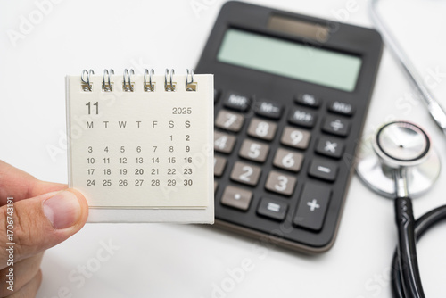 Medical Appointment Concept with 2025 November Calendar, Calculator and Stethoscope. symbolizing healthcare appointments, medical checkups, and patient consultation scheduling.