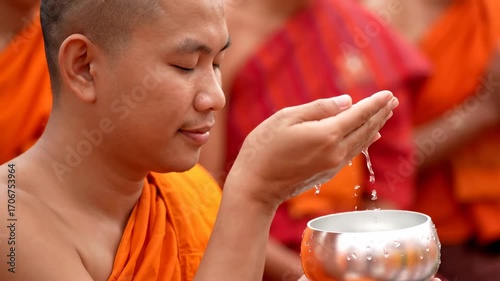 Close up monk blessing devotees holy water cinematic UHD Songkran cultural tradition stock video. cleric sanctification follower sacred liquid filmic ultra high definition thai