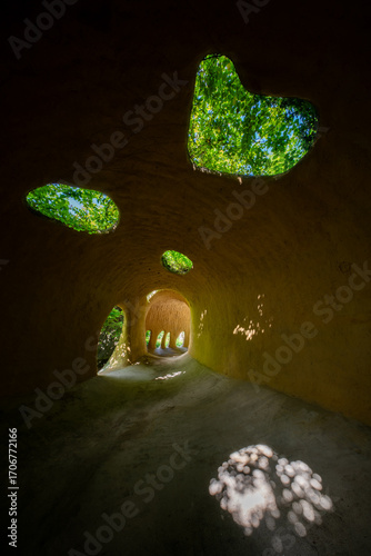 Underground Cave Interior with Multiple Natural Skylights and Stone Formations on Floor