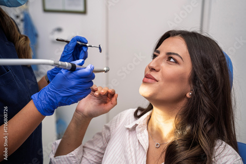 Young woman confused having second thought afraid of the dentist, rejects dentist with hand gesture