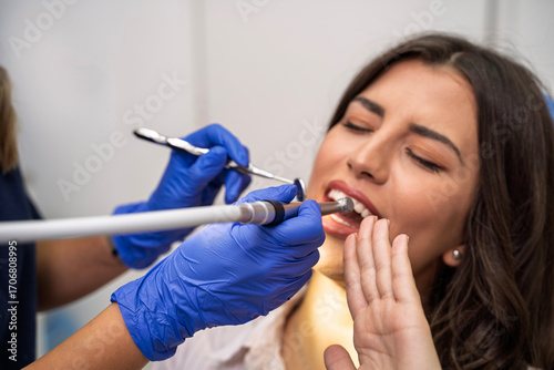 Young woman afraid of the dentist, rejects dentist with hand gesture , closeup shot 