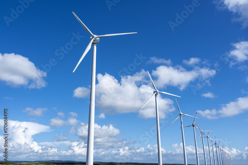 A row of many wind power plants on the wilderness near the coast in northern Hokkaido, Japan