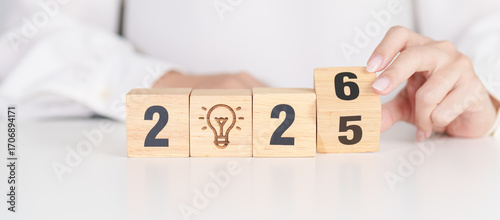 Canvas Print 2025 year change to 2026 year block with lightbulb