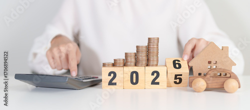 Fotografie 2025 end year to Happy New Year 2026 with car and Home model with coin stack