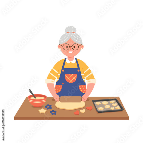 Happy elderly woman in an apron baking cookies.