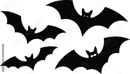 Four black bat silhouettes flying on white background