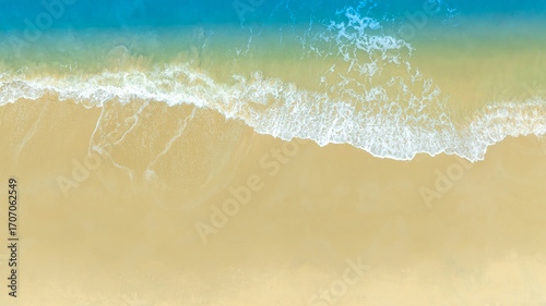 Beach sand background for summer vacation concept. Beach nature and summer seawater with sunlight light sandy beach Sparkling sea water	
