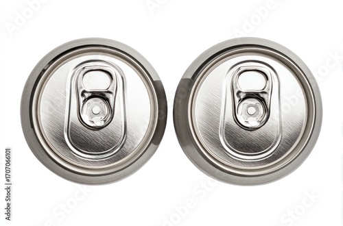 Overhead view of two shiny, silver aluminum beverage cans side by side, showing their tops with pull tabs, isolated on a white background