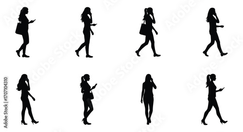Silhouette of Businesswomen Walking and Talking on Phones or Using Mobile Devices