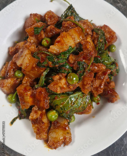 Stir-fried pork belly with curry paste. Pork belly stir-fried with curry paste. Thai food. Spicy. Pork with herbs. Thai food. Pork. Spices. Herbs   