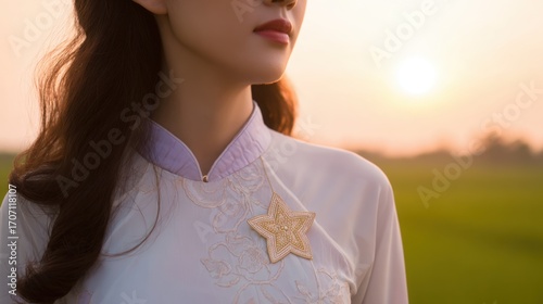 ao. Golden star-shaped brooch on silk ao dai collar, shallow depth of field with blurred sunset, symbolizing national pride. inspiring travel planning.