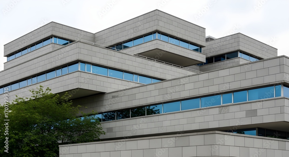 Obraz premium Modern Angular Concrete Building Architecture with Blue Windows - Corporate Design, Contemporary Urban Structure