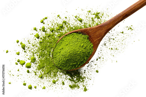 Wooden spoon holds matcha powder, scattered on a backdrop